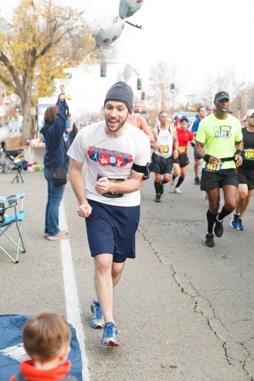 smiling guy running a marathon.
