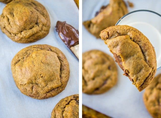 Fresh cookies from the oven with nutella on a knife, half of a gingerbread cookie stuffed with nutella on top of a glass of milk.