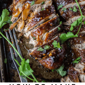 Sliced glazed pork tenderloin on a baking sheet, garnished with fresh cilantro and lime wedges. A fork rests beside the meat. Text reads: Asian Style Pork Tenderloin featuring bold flavors. The Food Charlatan.