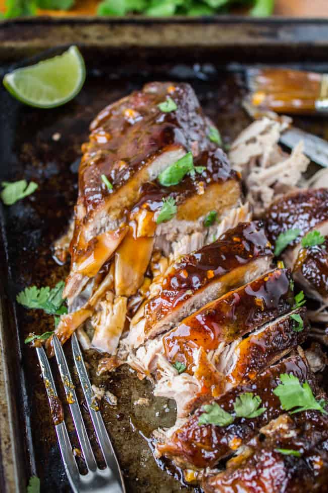 sliced slow cooker pork tenderloin with glaze and cilantro.