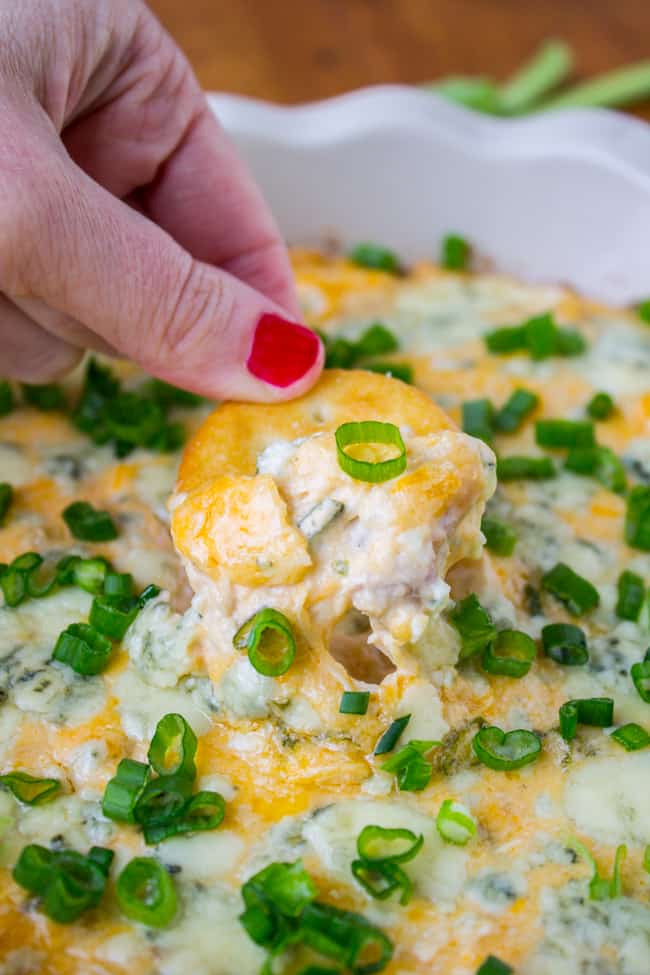 Cracker in chicken dip with frank's hot sauce