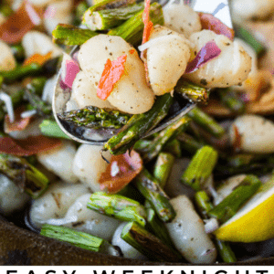 A spoon holds gnocchi with asparagus, red onion, and brown butter sauce above a skillet of the same dish. Text below reads: Easy Weeknight Brown Butter Gnocchi with asparagus, The Food Charlatan.