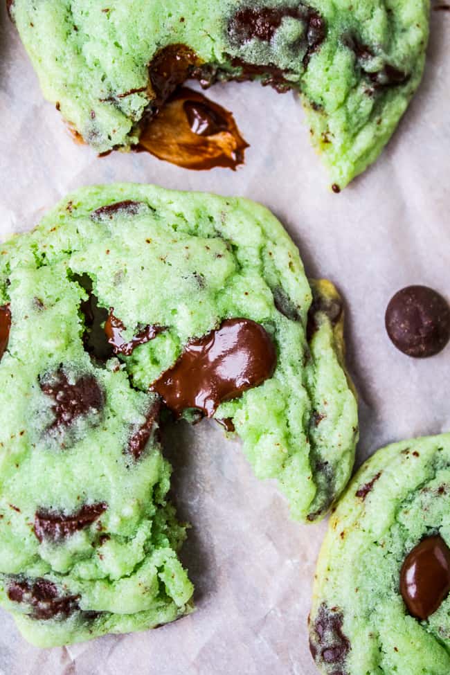 two green Chocolate Chip Cookies shot from overhead, one broken