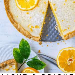 meyer lemon tart with a slice cut from it.