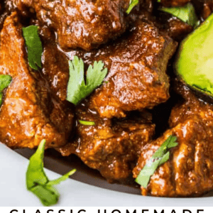 Close-up of tender beef chunks in a rich, brown sauce, garnished with fresh cilantro and a slice of lime. Text reads: Classic Tejano Carne Guisada (Braised Beef) The Food Charlatan.