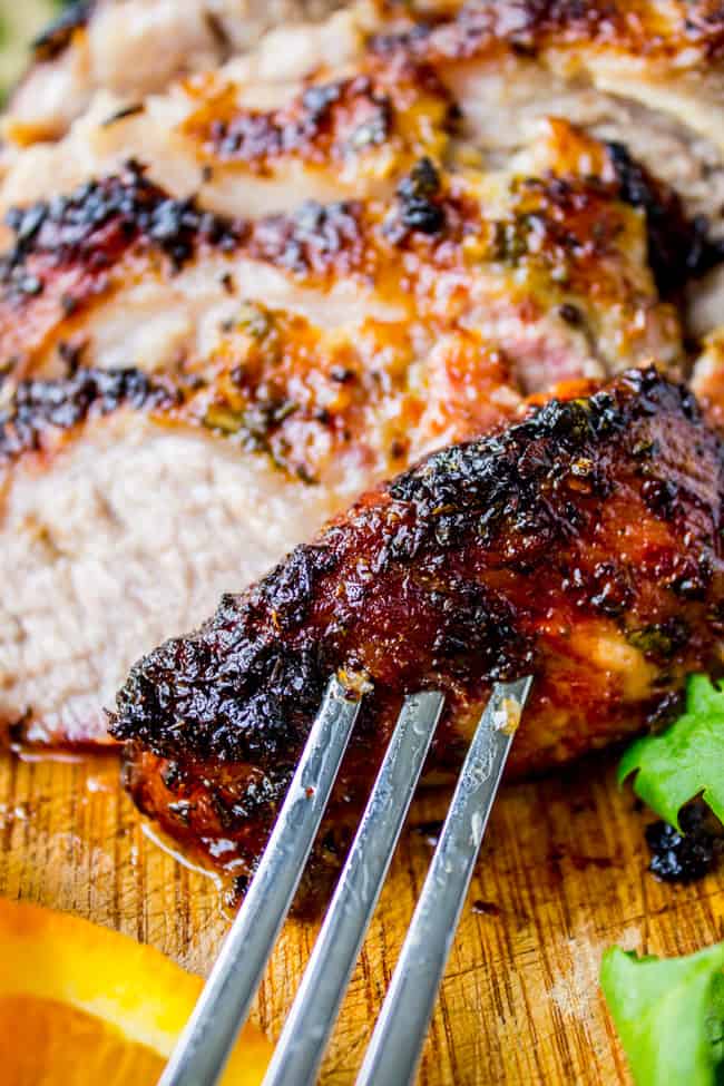 roasted cuban mojo pork (lechon asado) on a fork closeup.