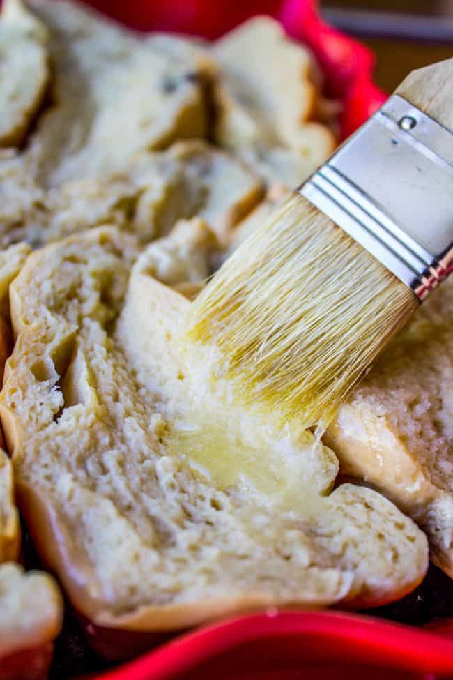 buttering top of french toast slices.
