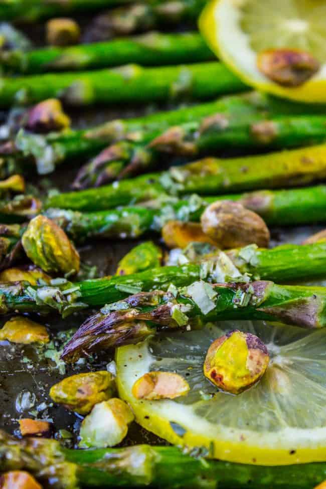 Lemon asparagus with pistachios and lemon slices. 
