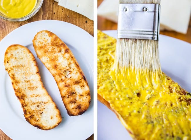 toasted bread, spreading mustard on toasted bread with a pastry brush.