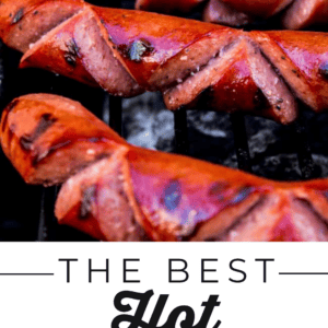 Three grilled hot dogs with diagonal score marks on a barbecue grill, served with jdawgs sauce and text reading The Best Hot Dogs Youve Ever Had below.