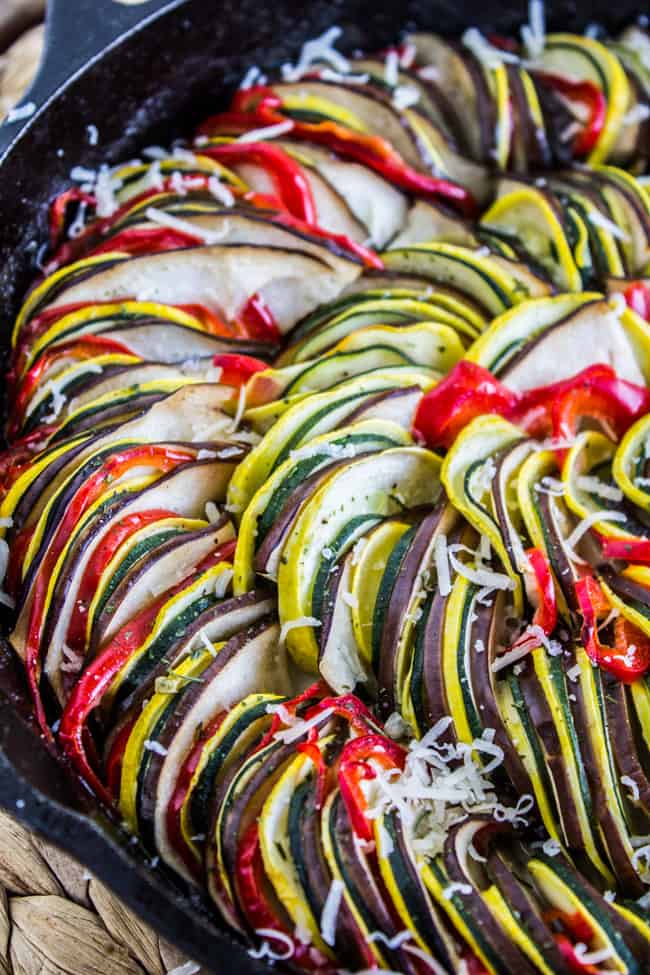 baked ratatouille in cast iron pan with sprinkled parmesan.