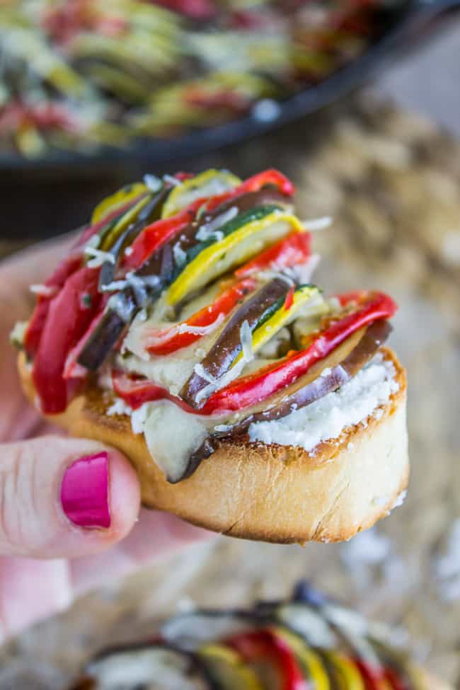 bite of ratatouille on top of toasted baguette slice.