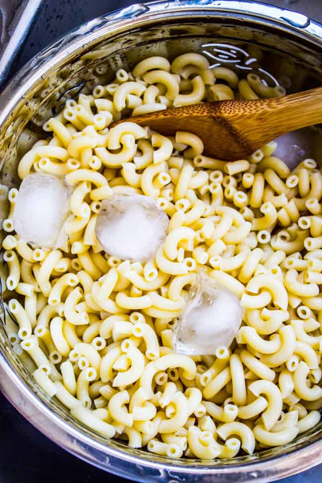 cooling cooked macaroni with ice cubes.