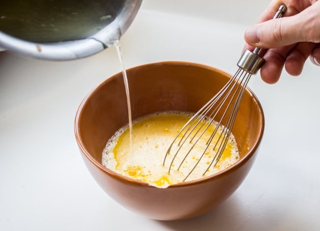 whisking eggs up in a small bowl.