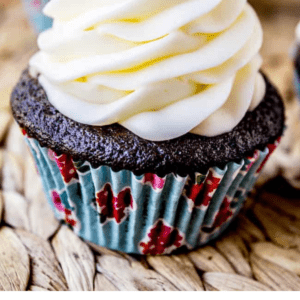 black bottom cupcake with a tall swirl of vanilla buttercream.