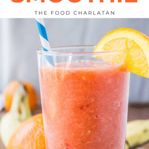 A glass of orange smoothie with a blue and white striped straw, garnished with an orange slice, with text above reading: 5 Minute Sunshine Smoothie - The Food Charlatan. This refreshing watermelon orange smoothie is perfect for a quick snack.