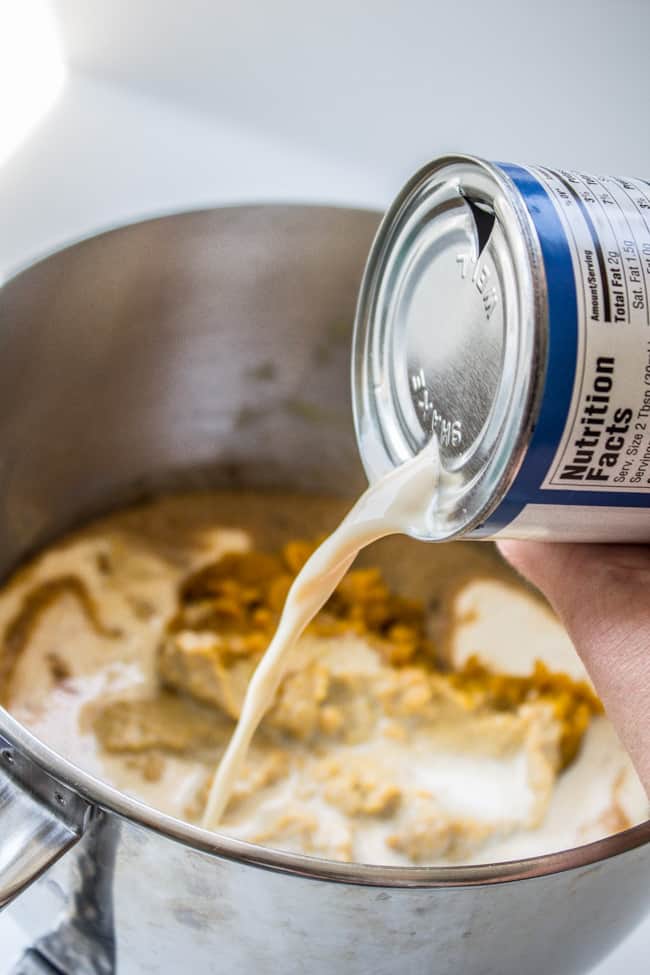 Pouring evaporated milk into mixer