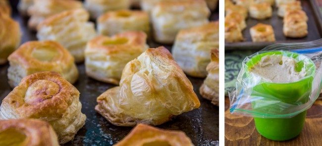 Freshly baked puff pastry shells on a baking tray on the left; on the right, a green cup with a plastic bag inside, filled with a creamy filling, ready to be piped into the pastries.
