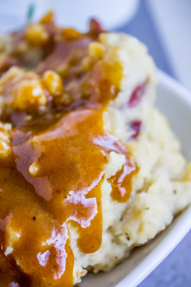 homemade turkey gravy dripping down red mashed potatoes.
