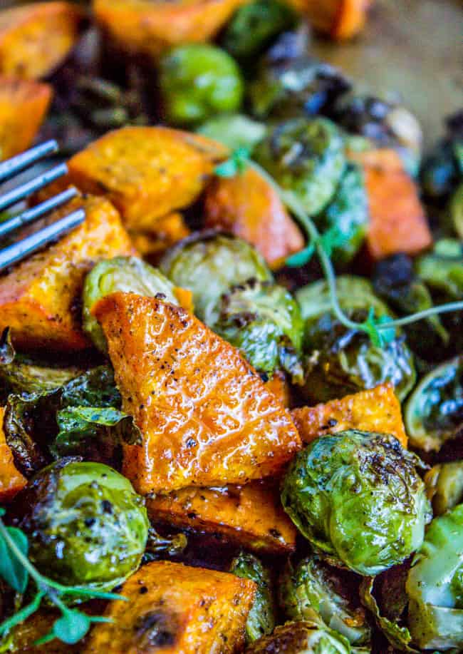 close up of roasted Sweet Potatoes and Brussels Sprouts shining with oil