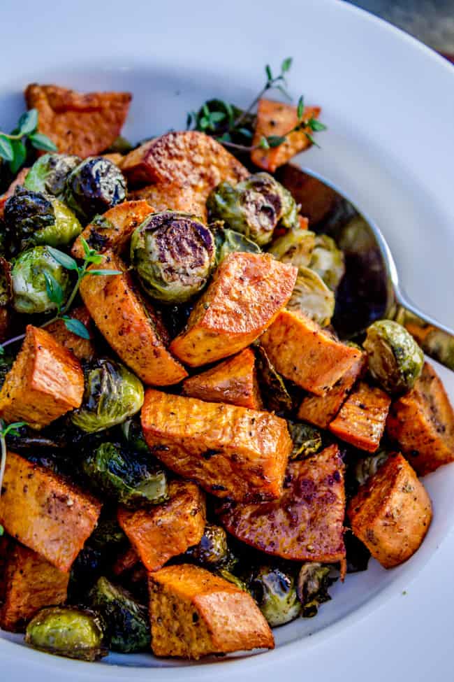 Spoon digging into roasted brussel sprouts and sweet potatoes