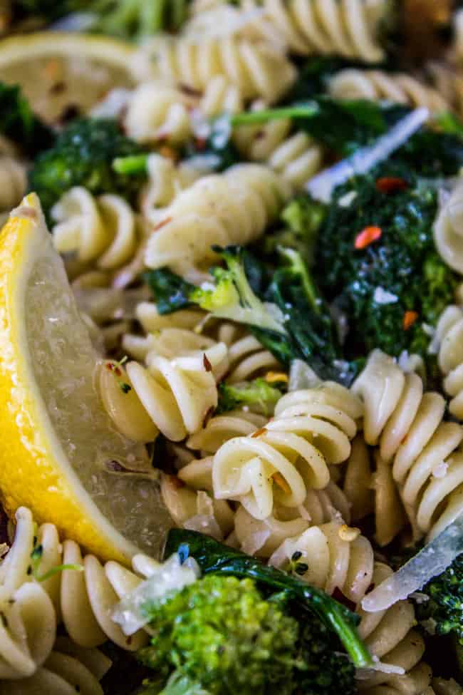 closeup of Broccoli Pasta with a lemon wedge.