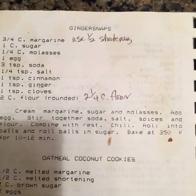 Page of old homemade cookbook with cookie recipes and personal notes added, clearly well-used.