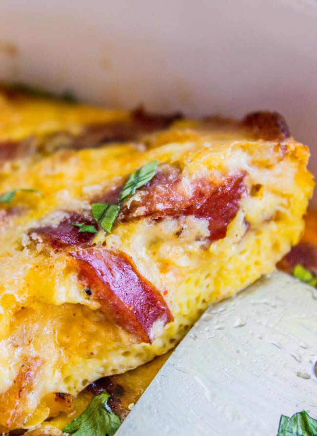 spatula lifting a section of scrambled egg casserole 