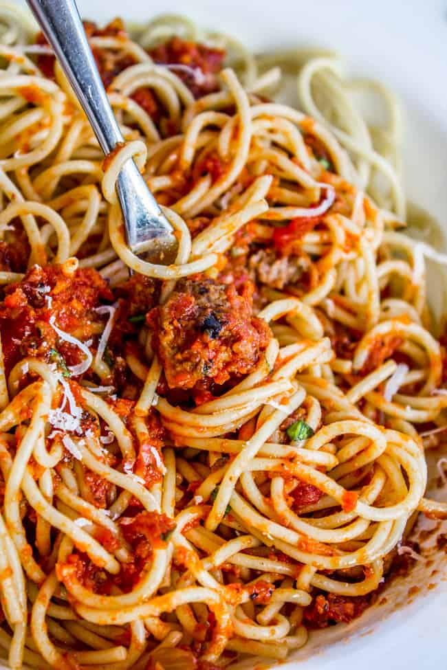 spaghetti sauce with Italian sausage served over spaghetti with a fork. 