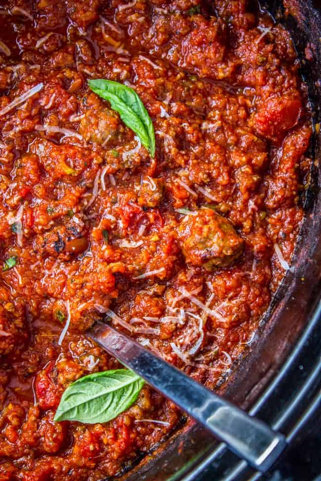 spaghetti sauce in the crockpot with fresh basil and shredded parmesan. 