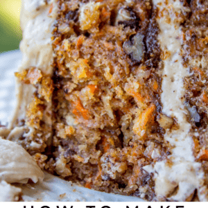 A close-up of a thick slice of classic carrot cake with visible carrot shreds, walnuts, and creamy frosting, accompanied by text that reads Classic Carrot Cake - The Food Charlatan.