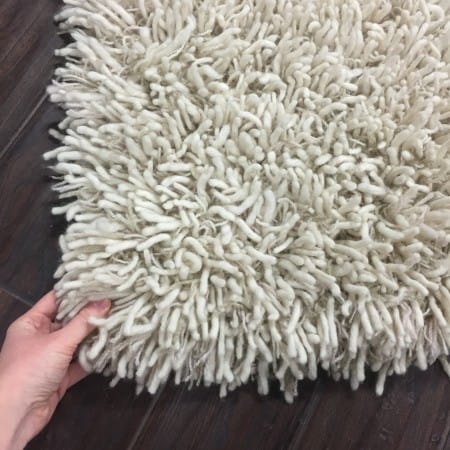 a corner of a thick, shaggy rug.