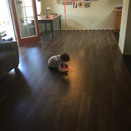 a small child on a freshly installed hardwood floor.
