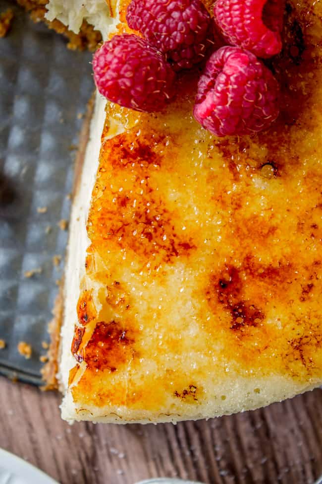 Crème Brûlée Cheesecake shot from above with fresh raspberries.