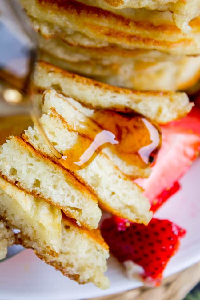 A stack of syrup covered pancake slices lined up on a fork.