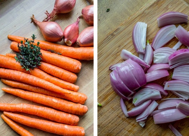 preparing shallots, carrots, and fresh thyme on a wooden cutting board.