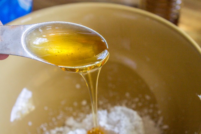 a spoonful of sweet honey topping for almond rolls. 