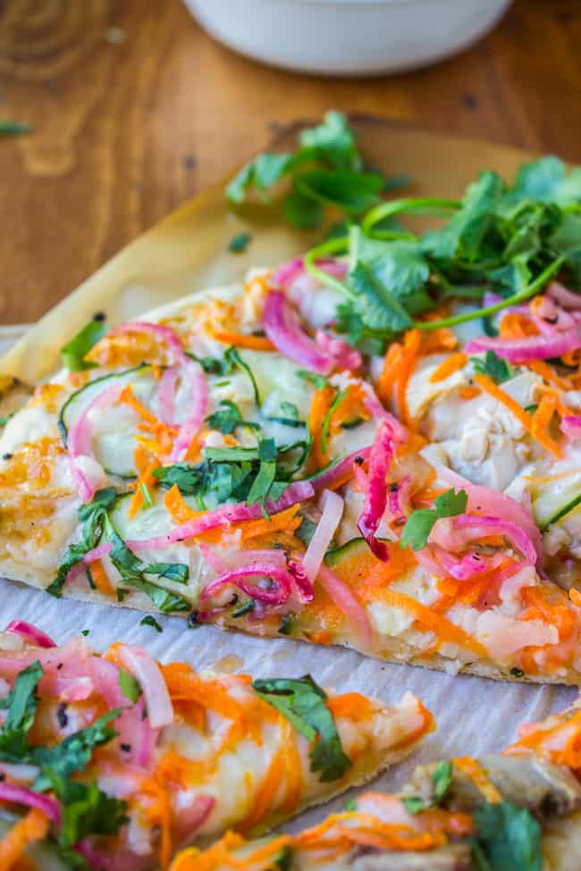 Slices of thai chicken pizza on table