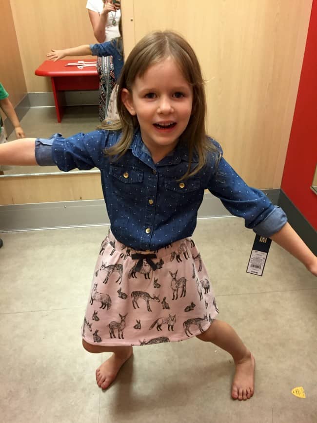 a little girl trying on clothes at Target.