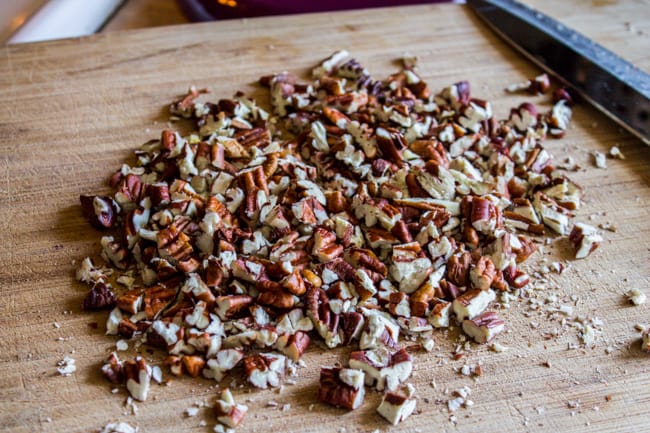 Chopped pecans on cutting board.
