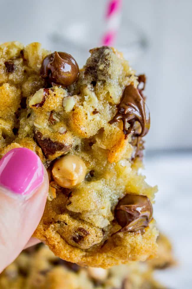 manicured hand holding a Texas cowboy cookie.