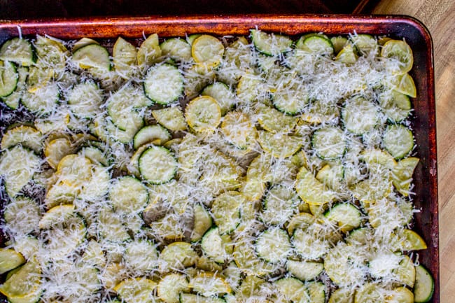 Parmesan, zucchini, and squash on a pan.