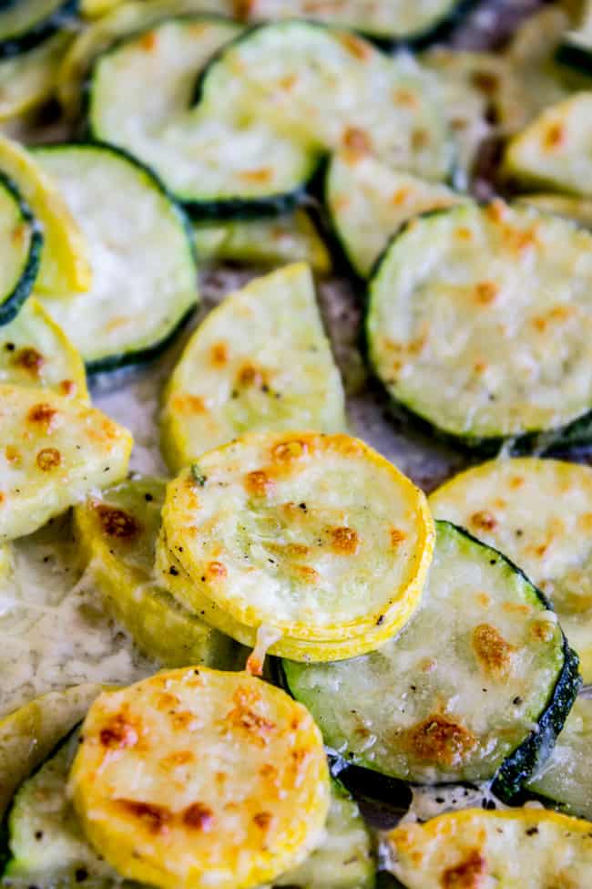 Baked parmesan zucchini and yellow squash on a pan.