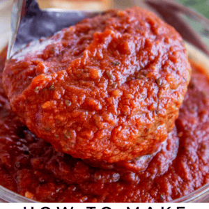 a ladle full of pizza sauce.