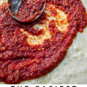 A metal ladle spreads chunky red pizza sauce over unbaked dough. Text below reads: The easiest No Cook Pizza Sauce - The Food Charlatan, featuring a flavorful blend of tomatoes and herbs.