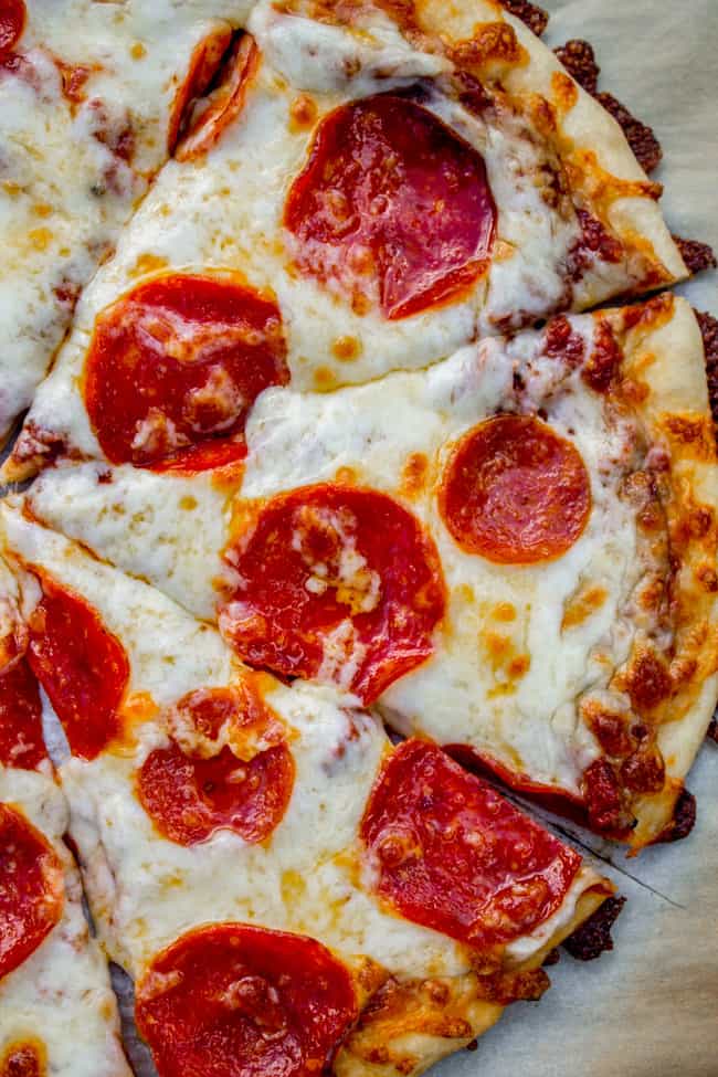 a homemade pepperoni pizza cut in slices. 