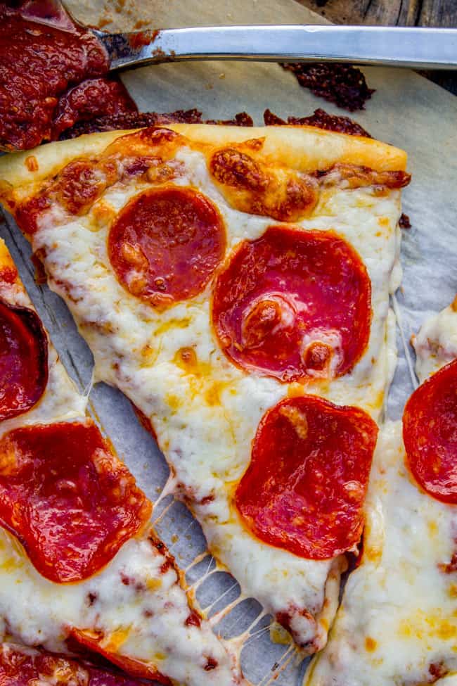 a slice of homemade pepperoni pizza on parchment paper. 