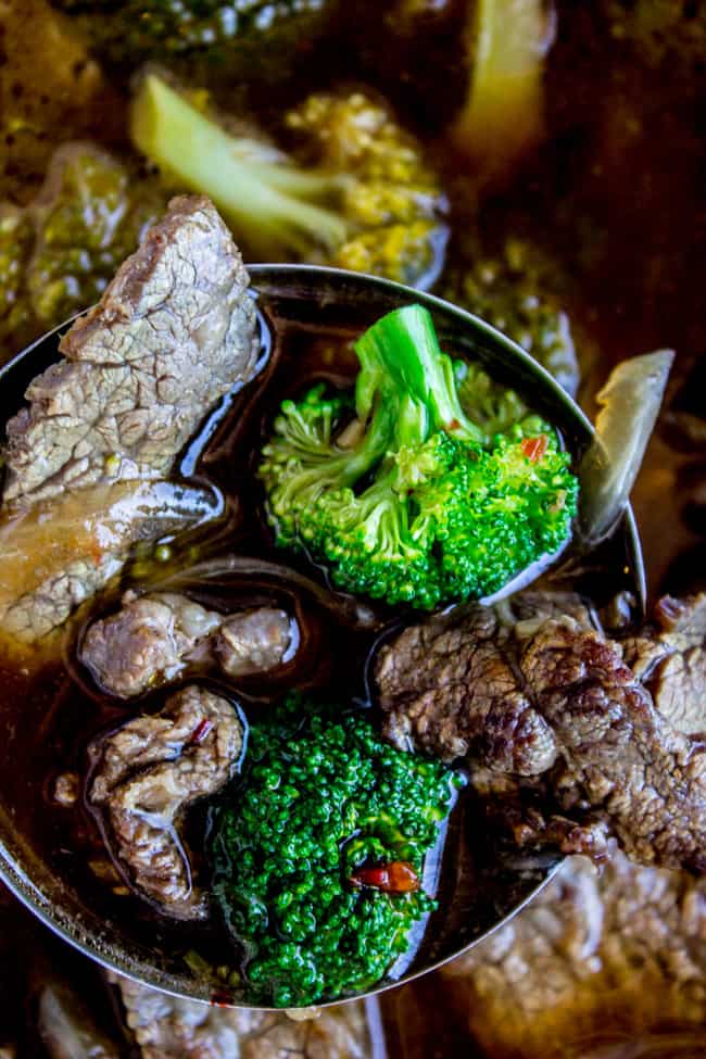 a ladle of beef and broccoli soup.