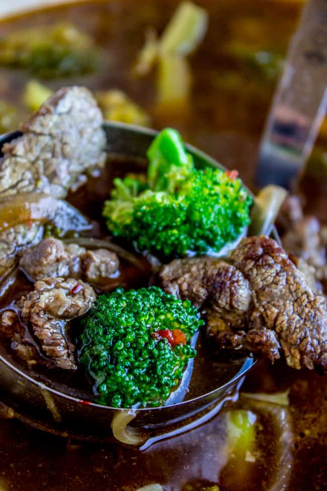 a ladle of beef and broccoli soup.