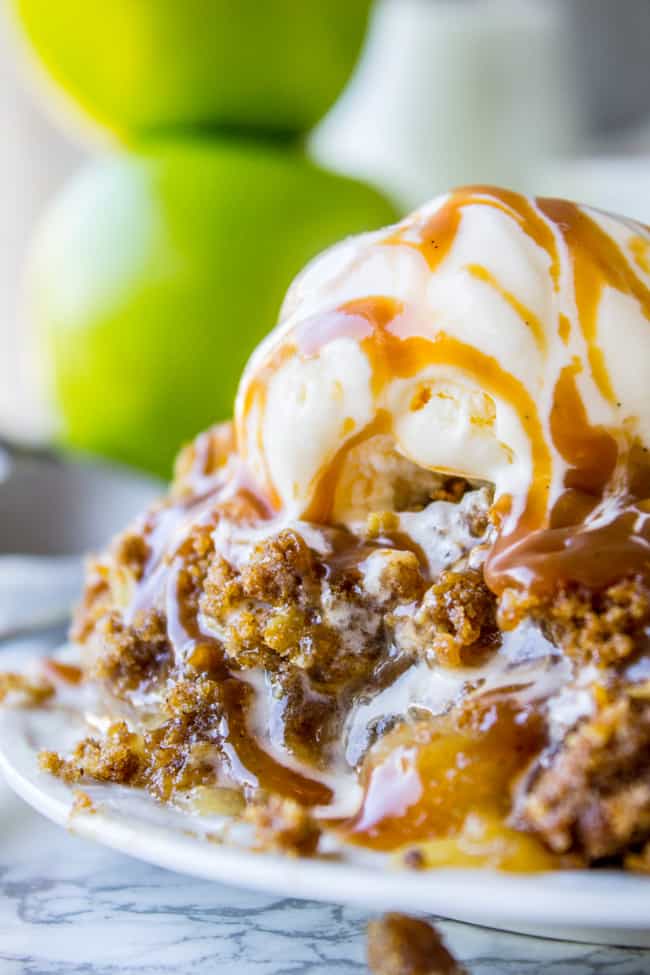 apple crisp recipe with oats topped with ice cream and caramel side view